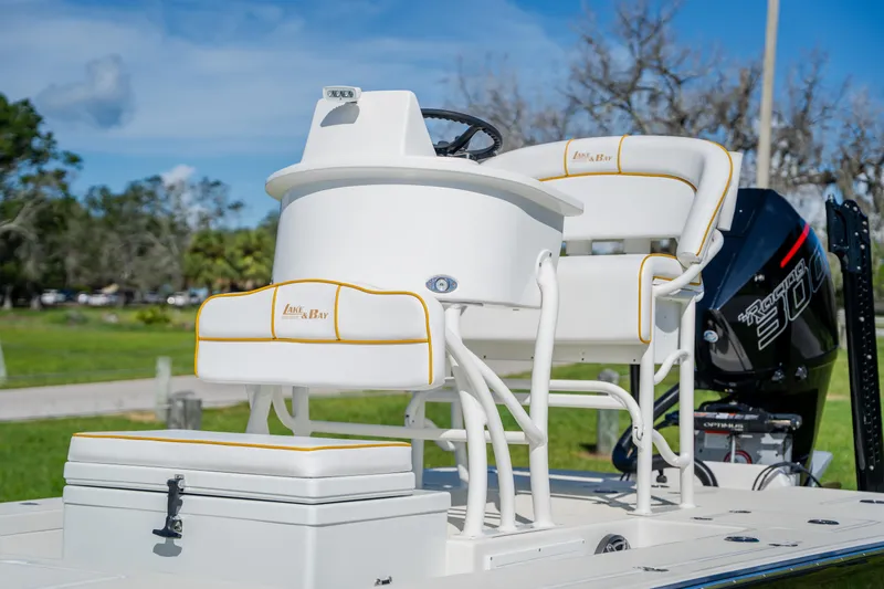 Slide: The Image of 2008 Lake & Bay Boca Grande 20 boat with white seating and powerful outboard motor. - 42