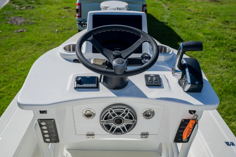 Slide: The Image of 2008 Lake & Bay Boca Grande 20 boat console with steering wheel and controls. - 46