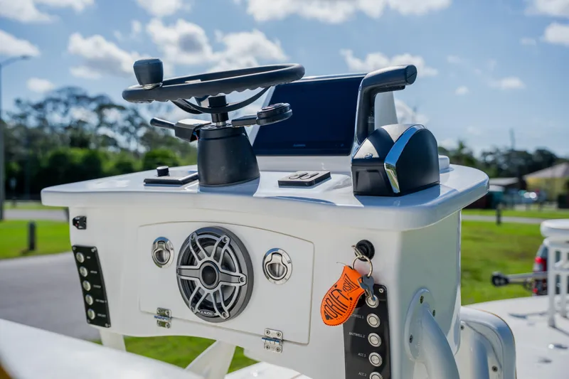 Slide: The Image of 2008 Lake & Bay Boca Grande 20 boat console with steering wheel and controls. - 47
