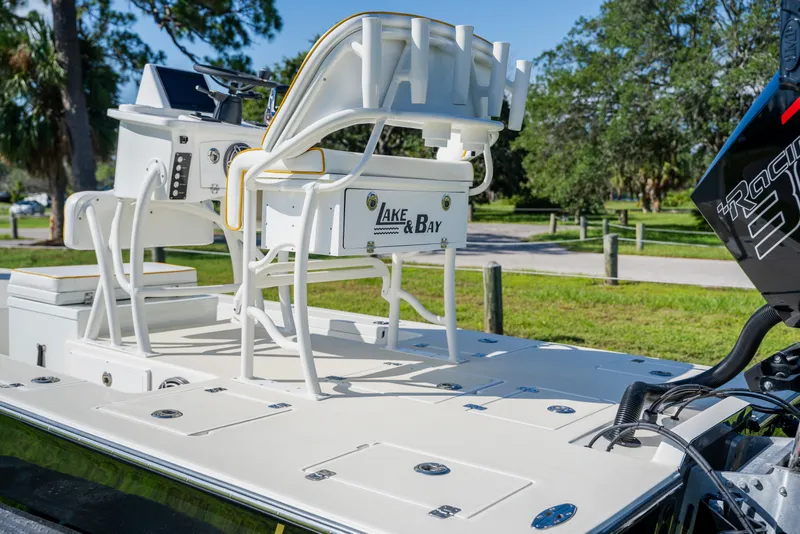 Slide: The Image of 2008 Lake & Bay Boca Grande 20 boat with white deck and seating, parked outdoors. - 49
