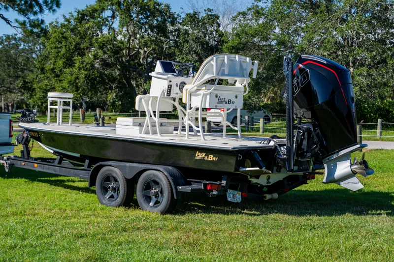 Slide: The Image of 2008 Lake & Bay Boca Grande 20 boat on trailer, parked on grass. - 5