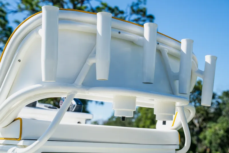Slide: The Image of Close-up of 2008 Lake & Bay Boca Grande 20 boat's rod holders against a clear sky. - 50
