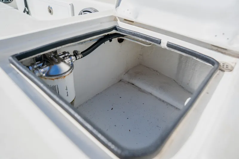 Slide: The Image of Open storage compartment in 2008 Lake & Bay Boca Grande 20 boat. - 64