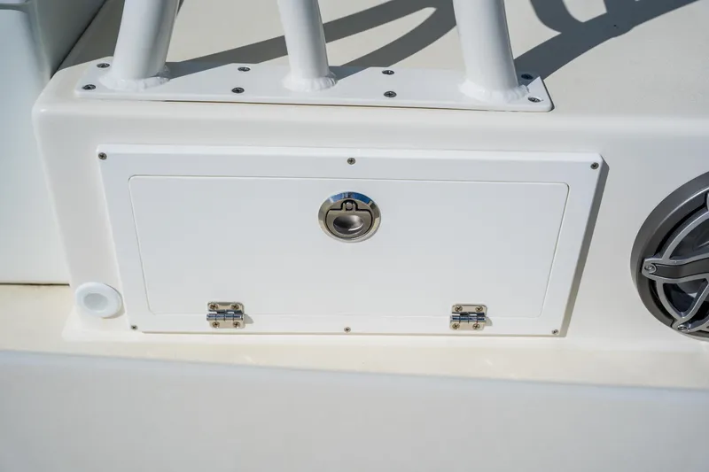 Slide: The Image of 2008 Lake & Bay Boca Grande 20 boat storage compartment with latch and speaker detail. - 67