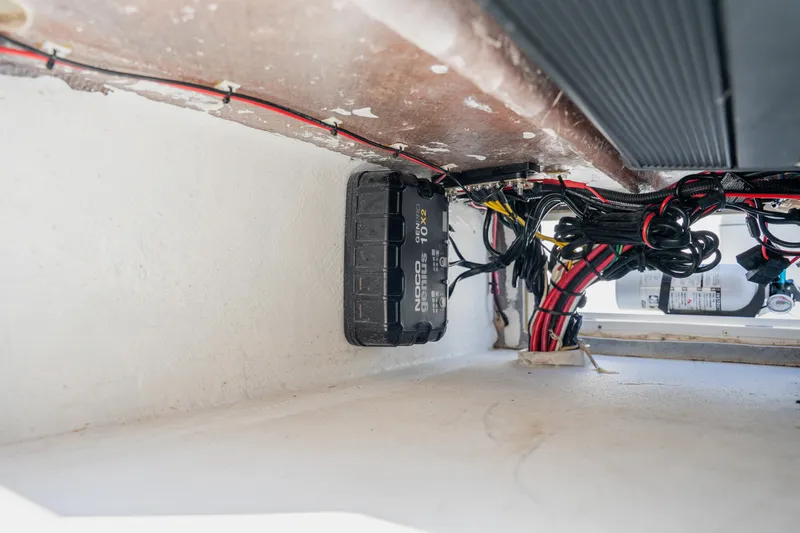 Slide: The Image of 2008 Lake & Bay Boca Grande 20 boat wiring and battery compartment with NOCO Genius charger. - 69