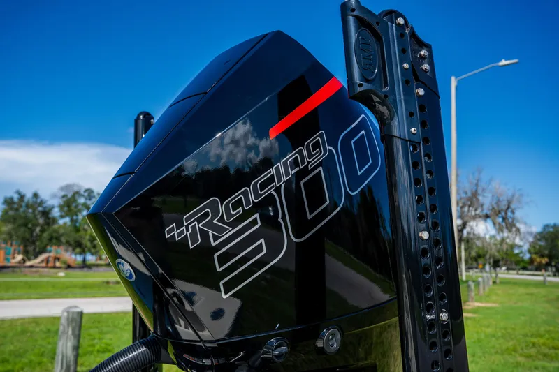 Slide: The Image of Close-up of a 2008 Lake & Bay Boca Grande 20 boat engine, featuring "Racing 300" branding. - 73