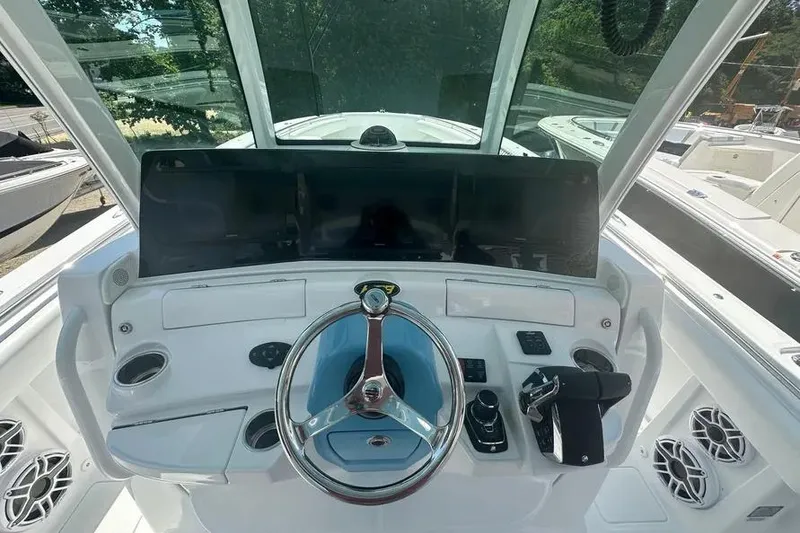 Slide: The Image of Helm of 2025 HCB 39 Speciale boat with modern controls and steering wheel. - 11