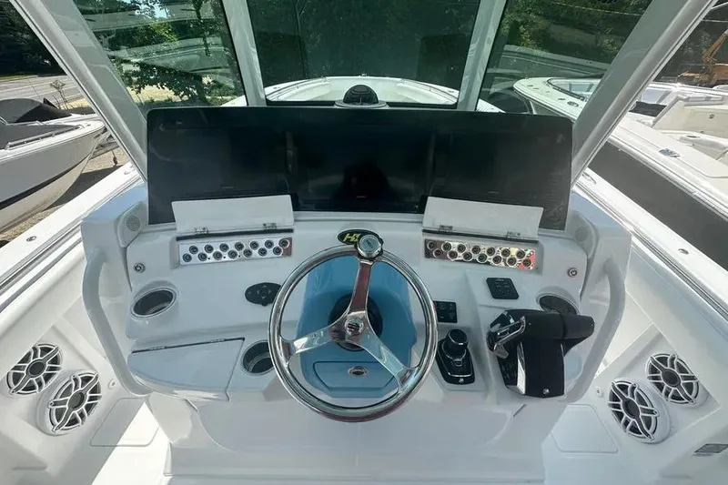 Slide: The Image of 2025 HCB 39 Speciale boat helm with modern controls and steering wheel. - 12