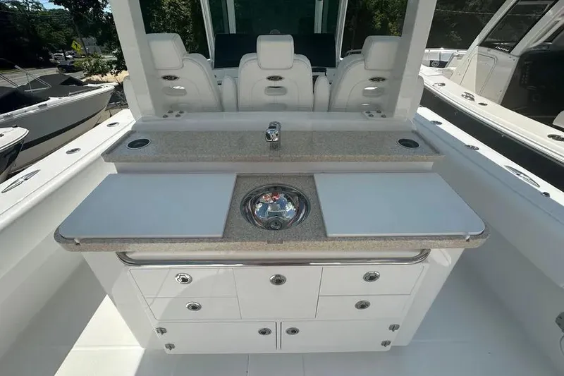 Slide: The Image of 2025 HCB 39 Speciale boat interior with sleek countertop and seating arrangement. - 15