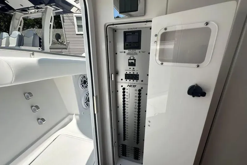Slide: The Image of Electrical panel inside 2025 HCB 39 Speciale boat, showcasing control switches and components. - 16