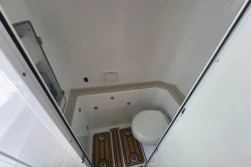 Slide: The Image of 2025 HCB 39 Speciale boat bathroom interior with toilet and wooden floor accents. - 17