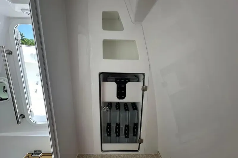 Slide: The Image of 2025 HCB 39 Speciale interior storage compartment with transparent door and organized shelves. - 18