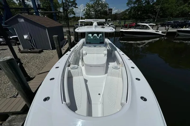 Slide: The Image of 2025 HCB 39 Speciale boat with sleek white design docked at marina. - 2
