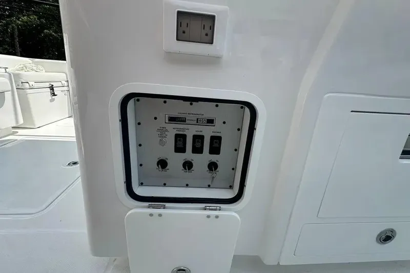 Slide: The Image of Control panel on 2025 HCB 39 Speciale boat, featuring switches and an outlet. - 23