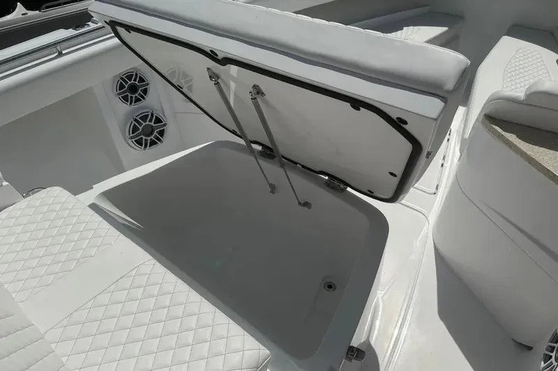 Slide: The Image of 2025 HCB 39 Speciale boat interior with open storage compartment and speakers. - 28