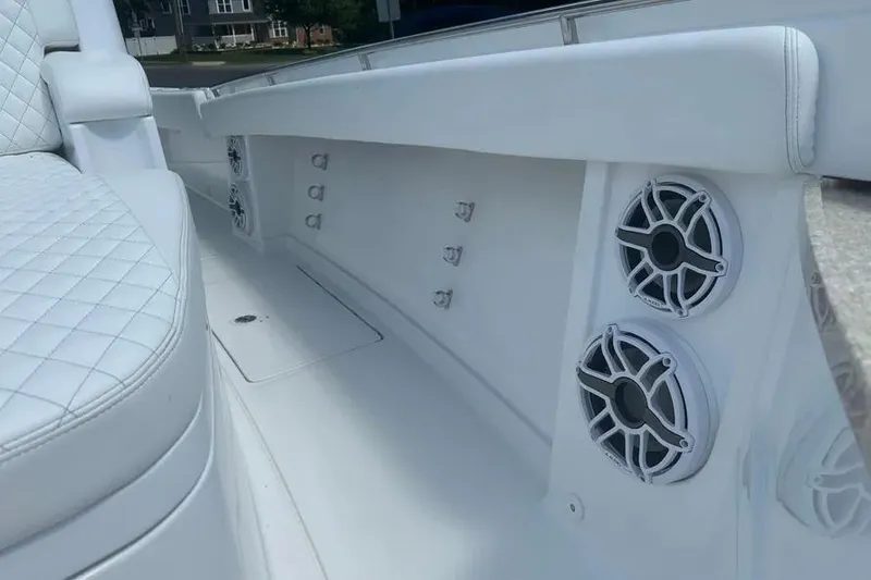 Slide: The Image of 2025 HCB 39 Speciale boat interior with white seating and built-in speakers. - 29