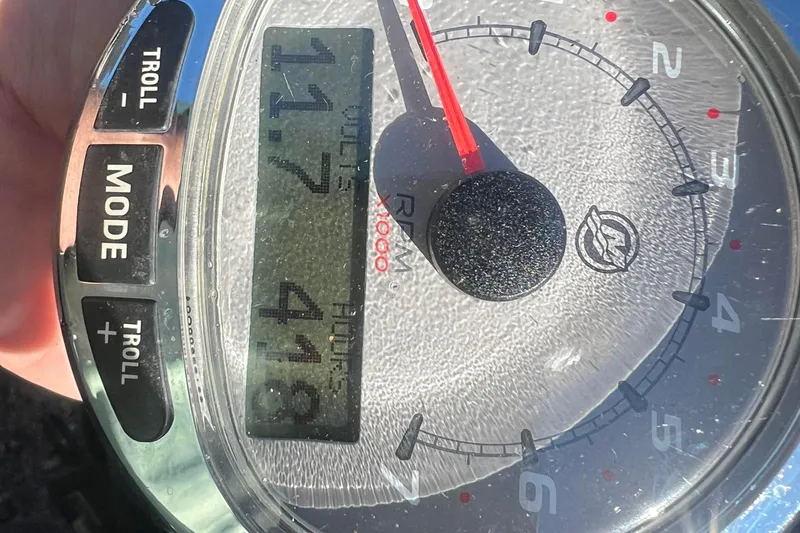 Slide: The Image of Close-up of a boat tachometer displaying 11.7 volts and 418 hours. - 12