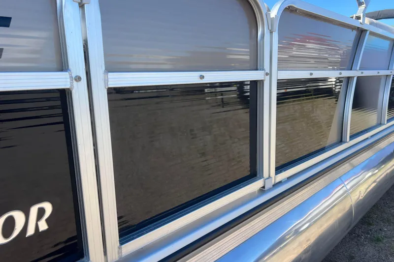 Slide: The Image of 2014 Misty Harbor 2285 Biscayne Bay CU pontoon boat side view, featuring sleek aluminum design. - 18