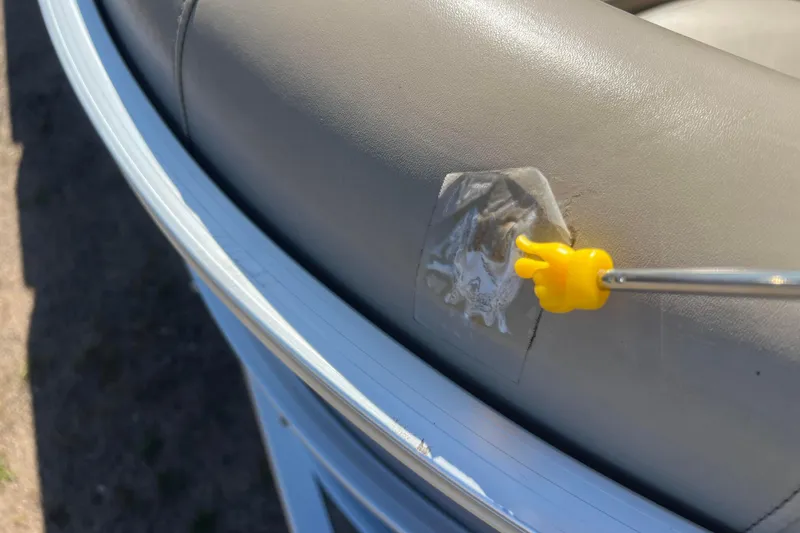 Slide: The Image of 2014 Misty Harbor 2285 Biscayne Bay CU boat seat with patch repair and yellow tool. - 25
