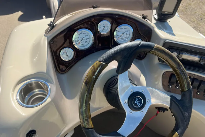 Slide: The Image of 2014 Misty Harbor 2285 Biscayne Bay CU boat dashboard with steering wheel and gauges. - 30