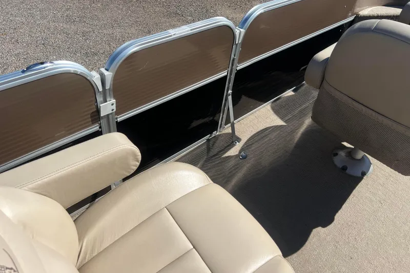 Slide: The Image of 2014 Misty Harbor 2285 Biscayne Bay CU boat interior with beige seating and metal railing. - 36