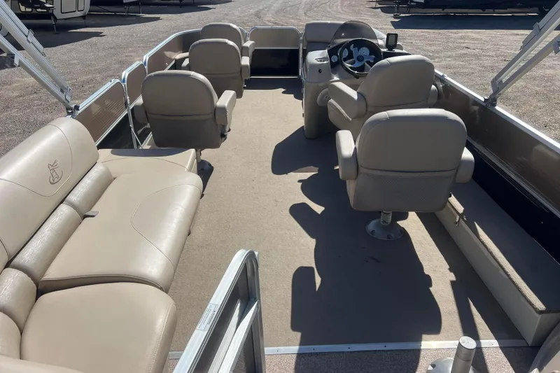 Slide: The Image of 2014 Misty Harbor 2285 Biscayne Bay CU pontoon boat interior with beige seating and steering console. - 6
