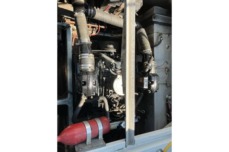 Slide: The Image of Engine compartment of a 1986 Carver Mariner 28 boat, showing mechanical components. - 17