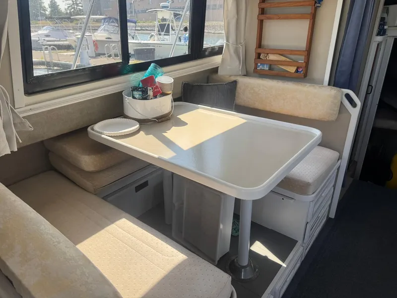 Slide: The Image of Interior of 1986 Carver Mariner 28 with dining area and window view. - 4