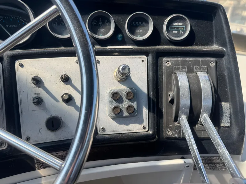 Slide: The Image of Control panel of a 1986 Carver Mariner 28 boat with steering wheel and gauges. - 8