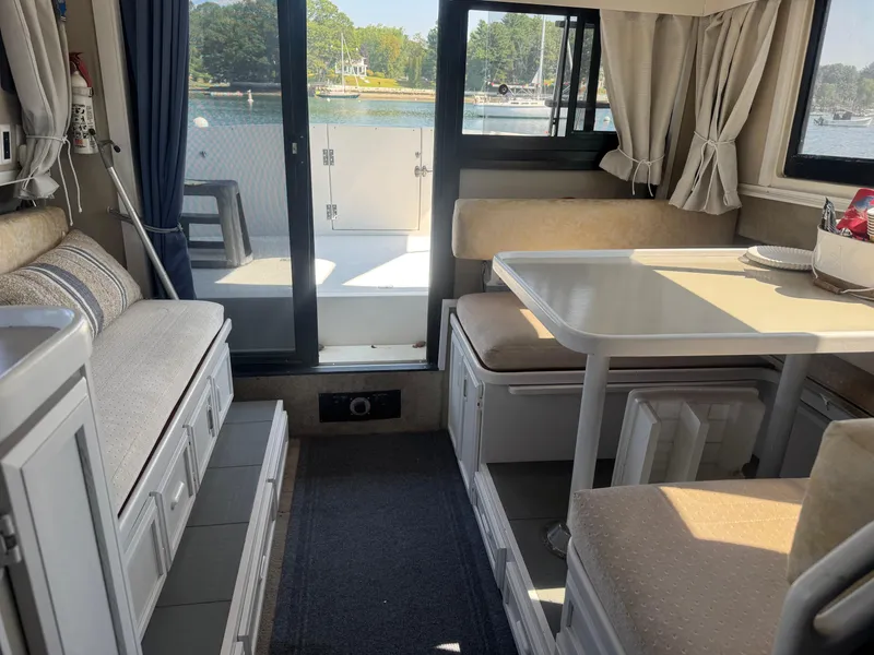 Slide: The Image of Interior of 1986 Carver Mariner 28 boat with dining area and scenic water view. - 12