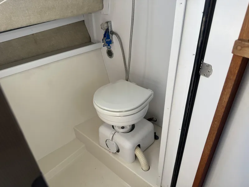 Slide: The Image of 1986 Carver Mariner 28 boat bathroom with compact marine toilet. - 14