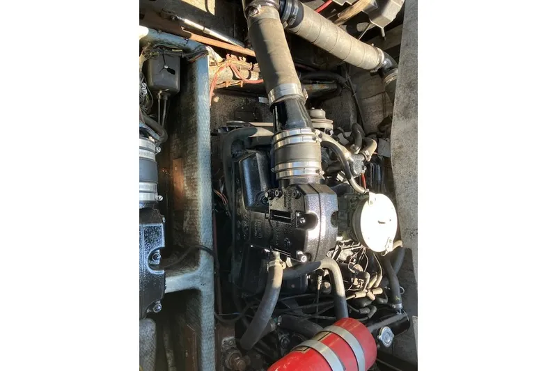 Slide: The Image of Engine compartment of a 1986 Carver Mariner 28 boat, showing mechanical components. - 15