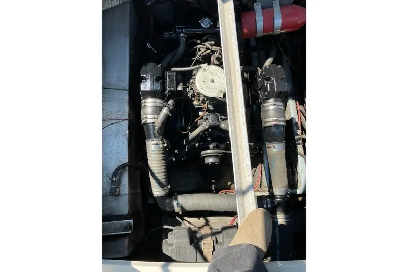 Slide: The Image of Engine compartment of a 1986 Carver Mariner 28 boat, showing mechanical components. - 16