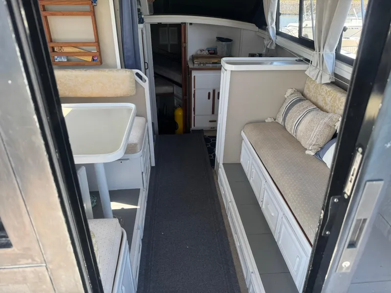 Slide: The Image of Interior of 1986 Carver Mariner 28 boat with seating and dining area. - 2