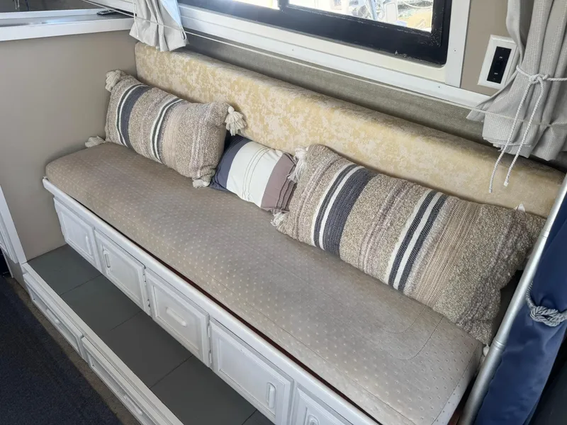 Slide: The Image of Interior seating area of a 1986 Carver Mariner 28 with decorative pillows. - 3