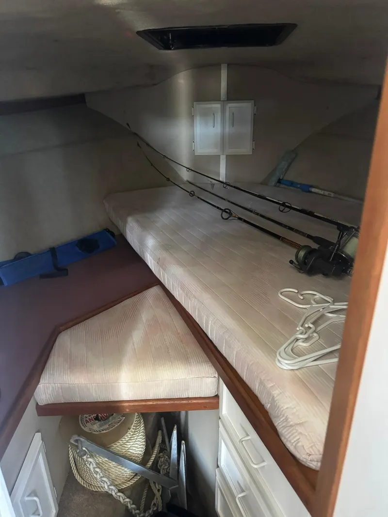 Slide: The Image of Interior cabin of 1986 Carver Mariner 28 with fishing rods and storage. - 5