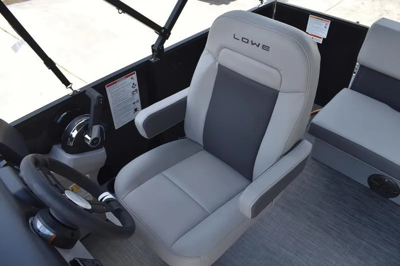 Slide: The Image of 2026 Lowe LS 170 boat interior with gray captain's chair and steering wheel. - 31