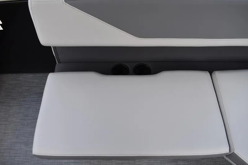 Slide: The Image of 2026 Lowe LS 170 boat storage compartment with battery and cup holders. - 42