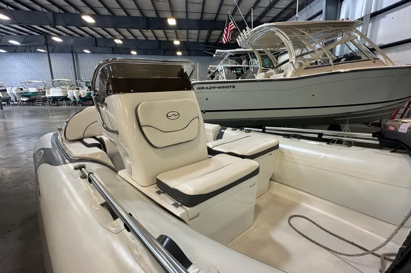 Slide: The Image of 2022 Walker Bay Venture 16 boat in showroom, featuring sleek design and comfortable seating. - 10