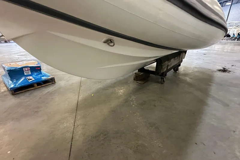 Slide: The Image of 2022 Walker Bay Venture 16 boat hull in a warehouse setting. - 12