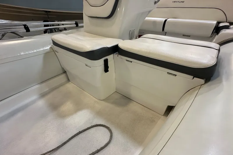 Slide: The Image of 2022 Walker Bay Venture 16 boat interior with cushioned seating and storage compartments. - 14