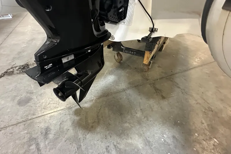 Slide: The Image of 2022 Walker Bay Venture 16 outboard motor on a workshop floor. - 17