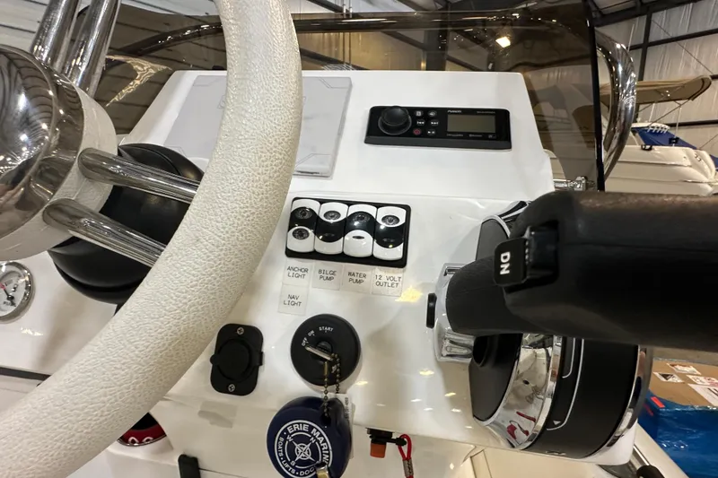 Slide: The Image of 2022 Walker Bay Venture 16 dashboard with steering wheel and control panel. - 19