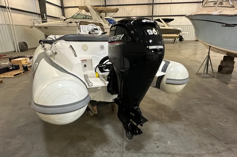 Slide: The Image of 2022 Walker Bay Venture 16 with Mercury 90 outboard motor in a boat storage facility. - 4