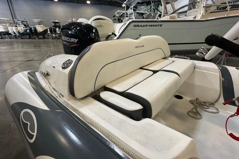 Slide: The Image of 2022 Walker Bay Venture 16 boat with Mercury engine in showroom. - 8