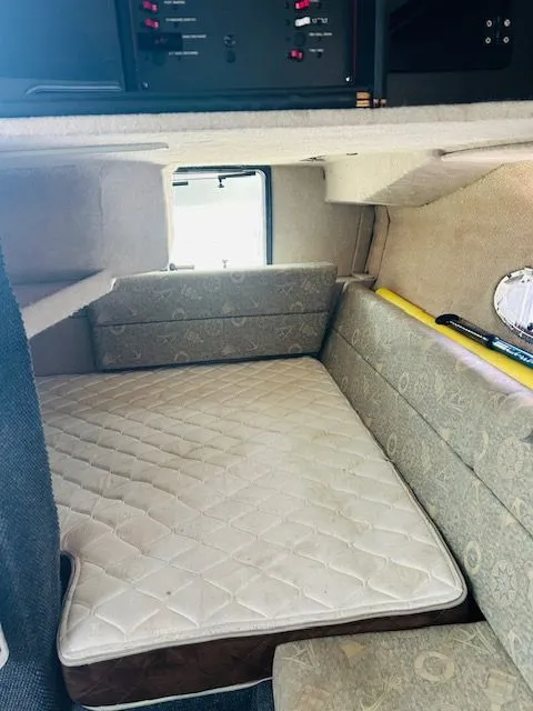 Slide: The Image of Interior cabin of 1989 Bayliner Avanti 3255 Sunbridge with cushioned seating and control panel. - 5