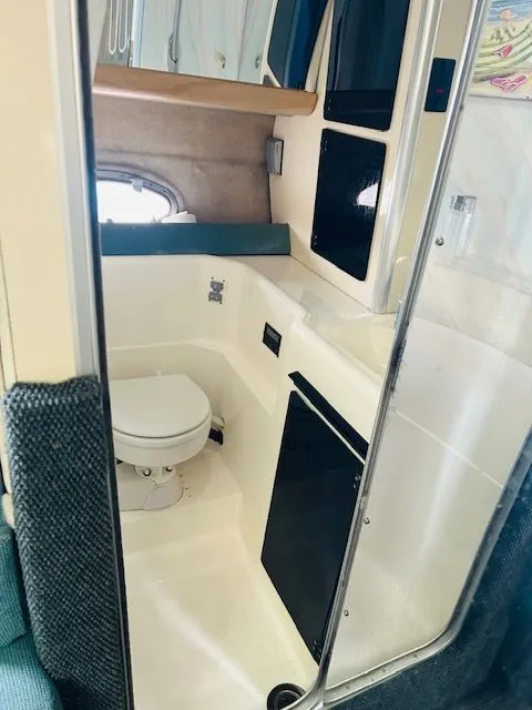 Slide: The Image of 1989 Bayliner Avanti 3255 Sunbridge bathroom interior with toilet and storage cabinets. - 9