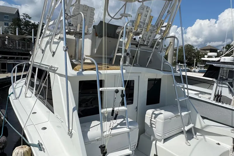 Slide: The Image of 1975 Chris-Craft 30 Tournament SF boat docked, featuring fishing equipment and upper deck seating. - 16