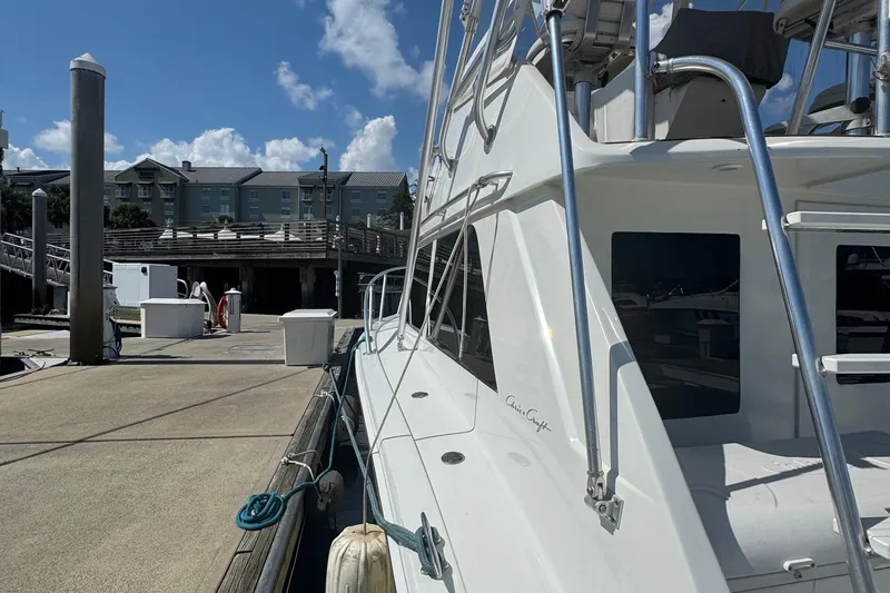 Slide: The Image of 1975 Chris Craft 30 Tournament SF yacht docked at a marina under a clear blue sky. - 17