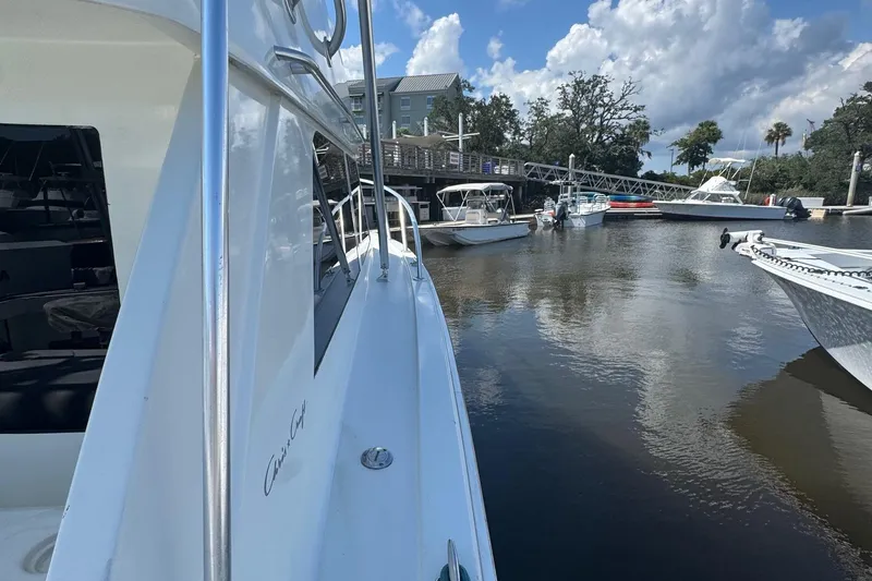 Slide: The Image of 1975 Chris Craft 30 Tournament SF docked in a serene marina setting. - 18
